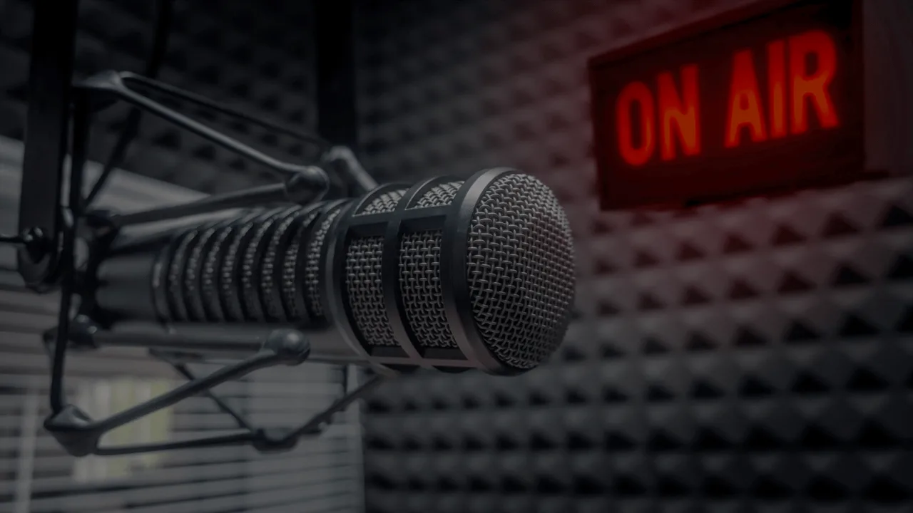 A radio studio microphone with an on-air sign